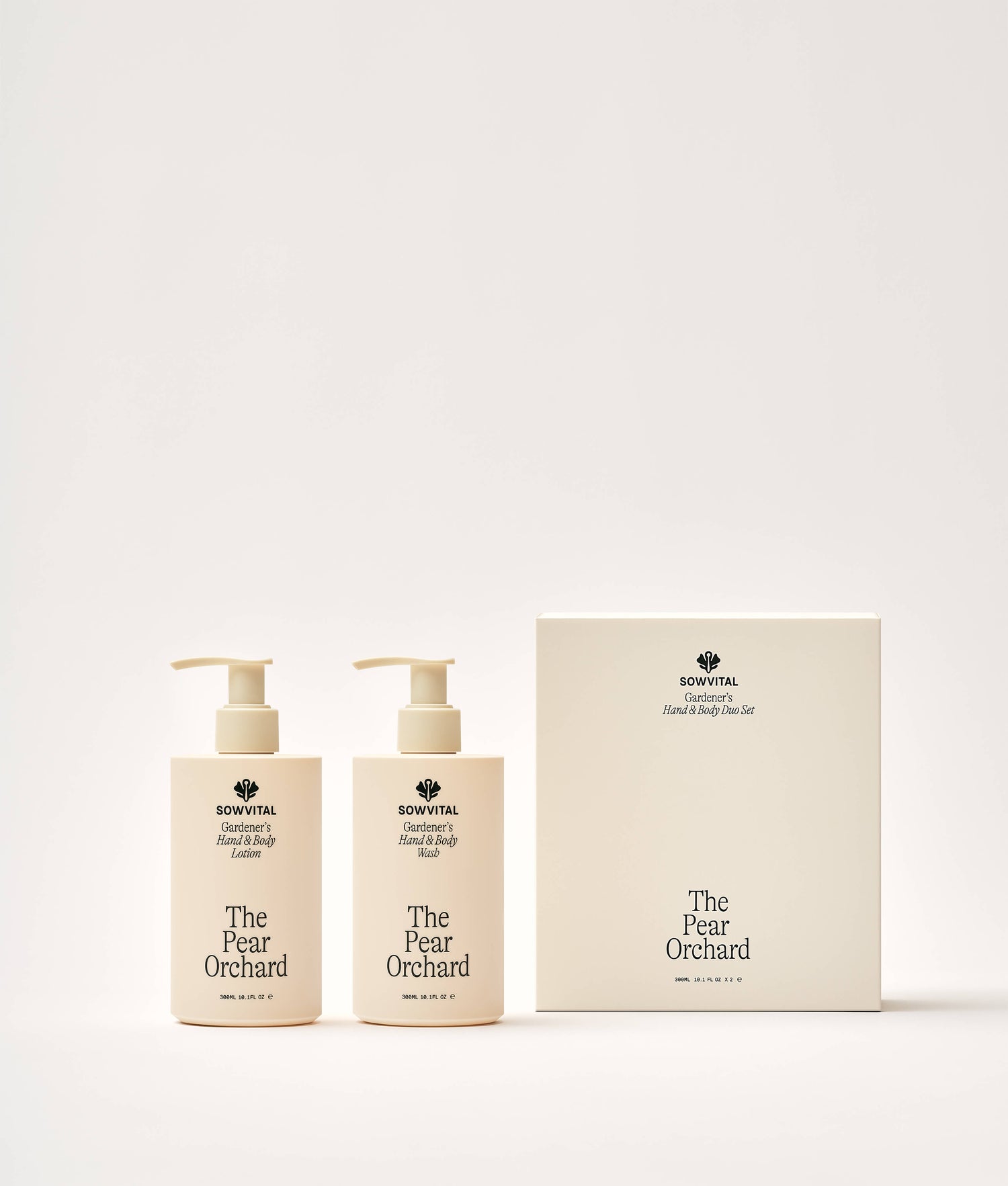 Two bottles and a box of 'The Pear Orchard' hand and body wash and lotion on a white background