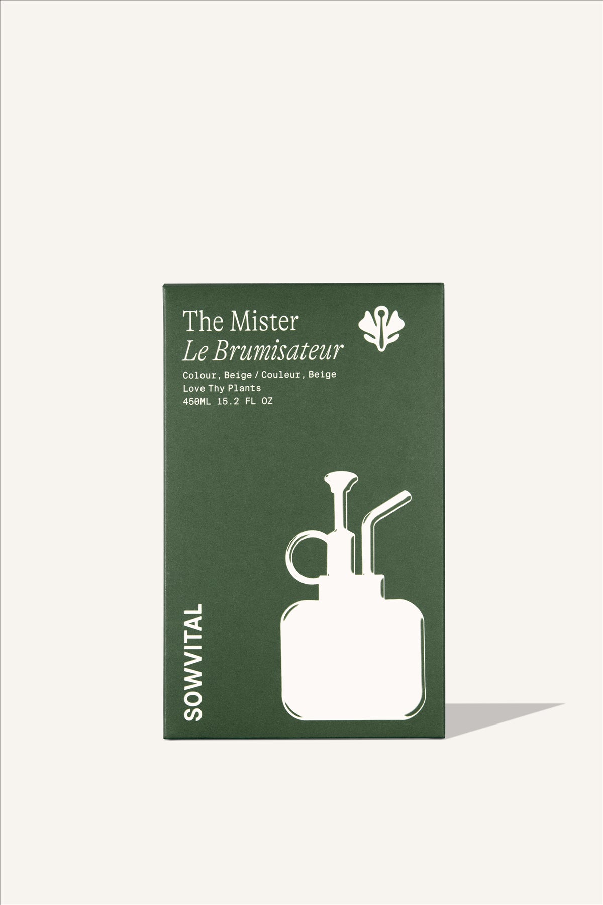 A tall rectangular green paper box, embossed with a beige illustration of the houseplant mister contained within. The background is beige.