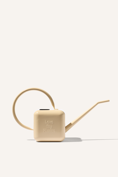 A beige stainless steel 1.25L watering can, embossed with the phrase "Love Thy Plants".