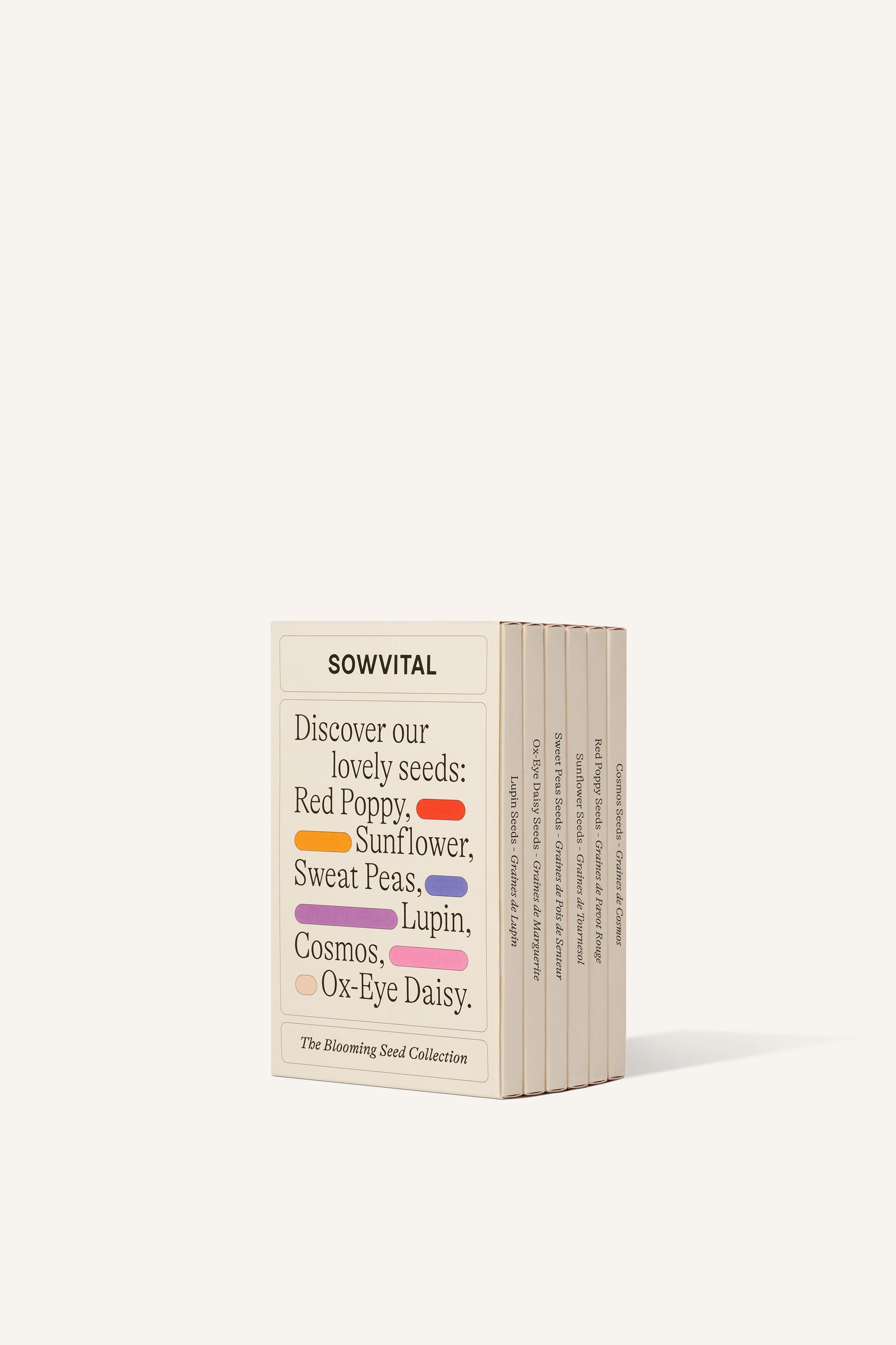 Sowvital's Flower Seed Collection from a corner angle. A rectangular fedrigoni paper sleeve describing the varieties found inside, Red Poppy, Sunflower, Sweet Peas, Lupin, Cosmos, and Ox-Eye Daisy. The background is beige.