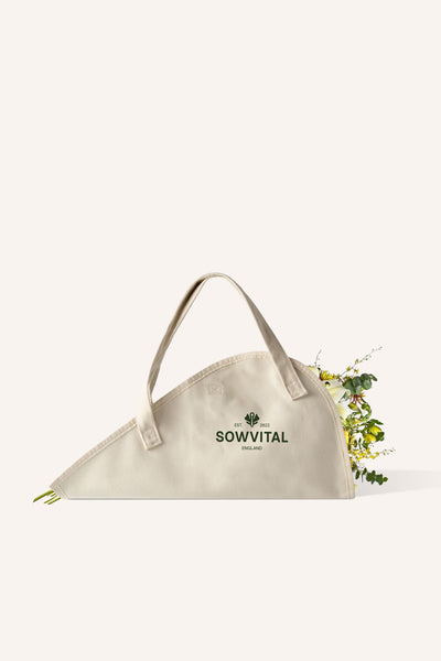 A beige cotton tote bag, specifically designed for carrying flowers, with the Sowvital logo on the side in green.