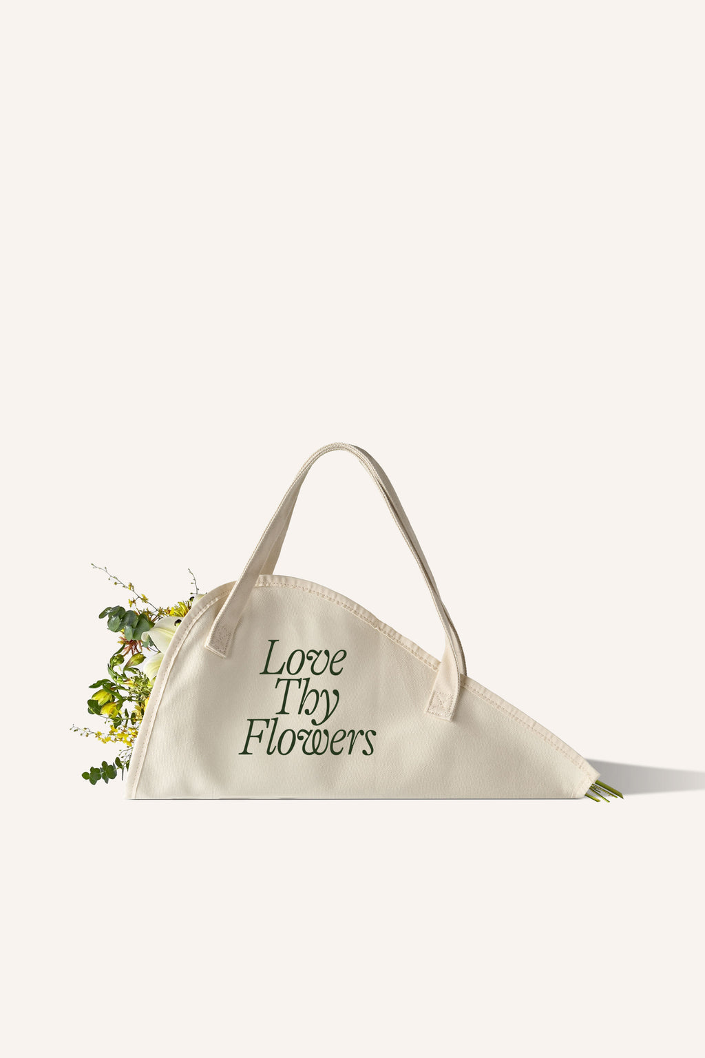 A beige cotton tote bag, specifically designed for carrying flowers, with the phrase "Love Thy Flowers" on the side in green.