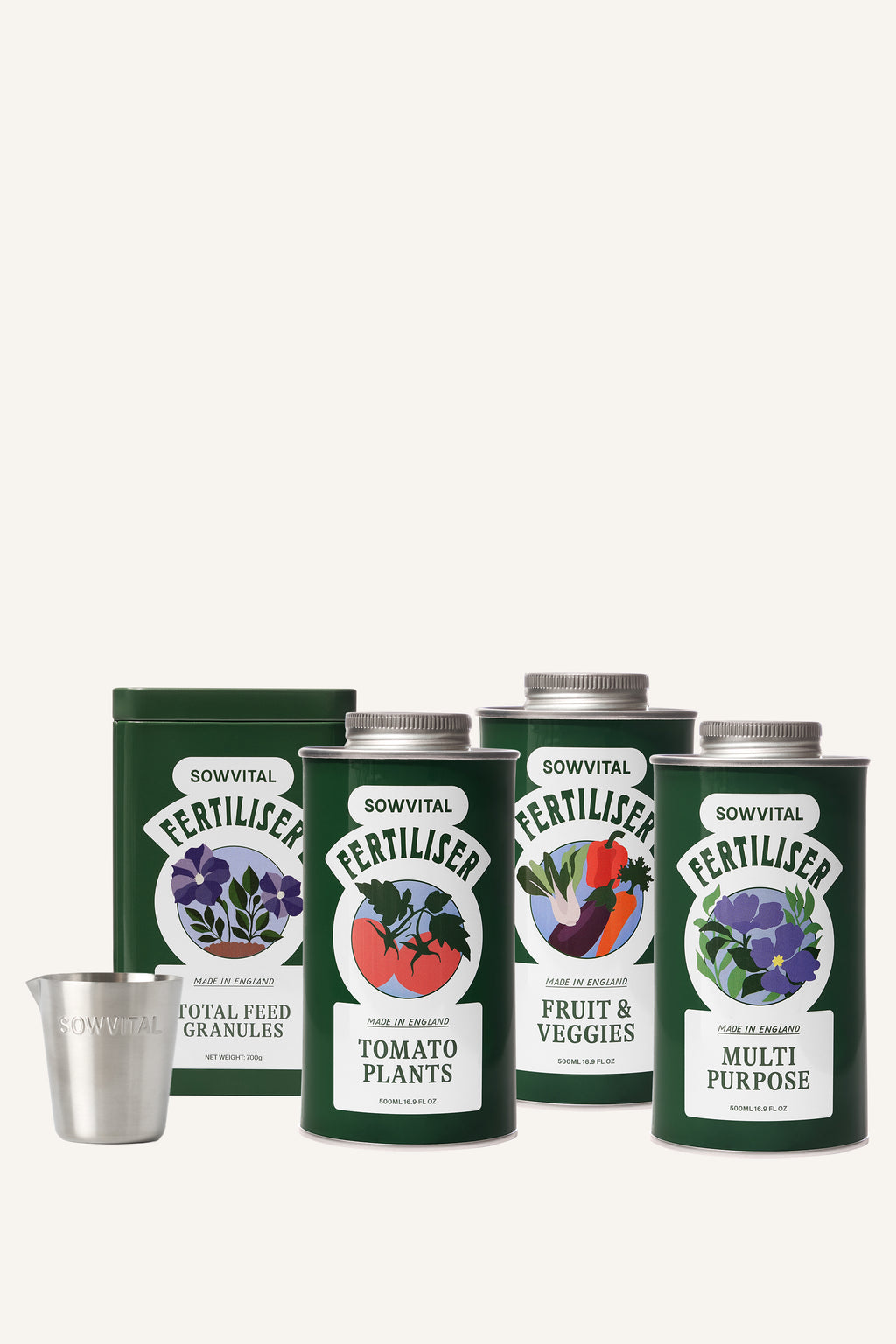 Four different green metal tins of garden fertilisers sit alongside a small metal measuring cup in front of a beige background.