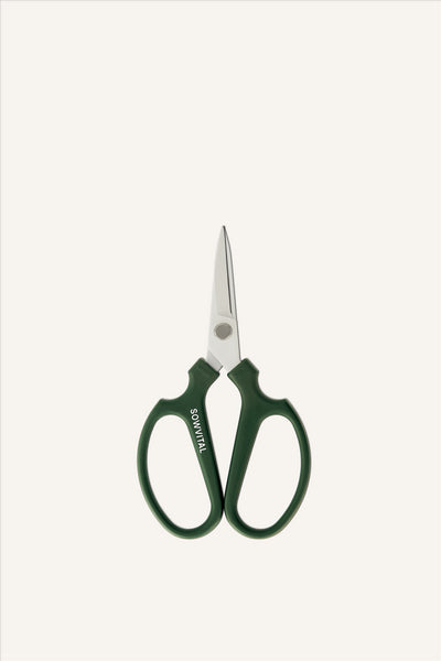 A pair of sharp looking pruning scissors with green handles and white metal blades. The left handle has the SOWVITAL logo written along it. The scissors are in a closed position. The background is beige.