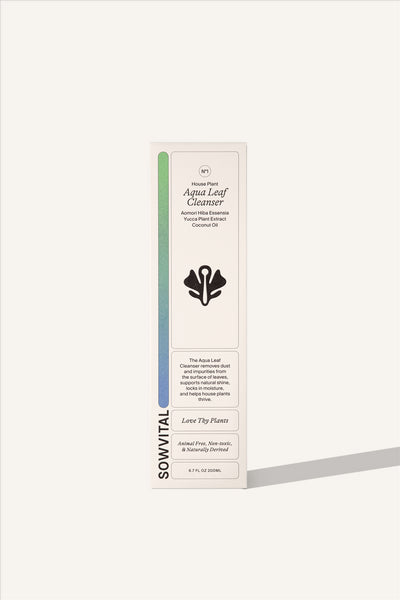 The box of the Sowvital Aqua Leaf Cleanser, a tall and narrow box constructed from beige fedrigoni paper, with a soft colour gradient running up one side. The background is beige.