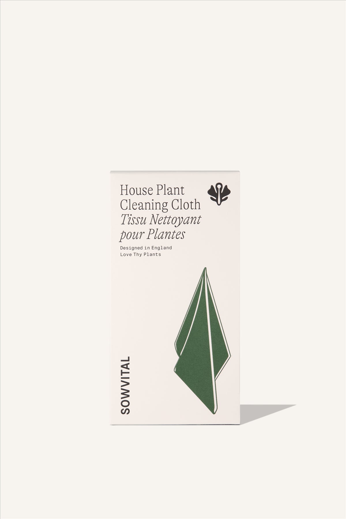 A tall rectangular beige fedrigoni paper box, embossed with a green illustration of a draped cleaning cloth. The background of the image is beige.