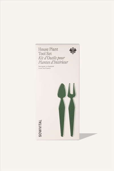 The House Plant Tool Set box, a tall rectangular beige fedrigoni paper box with an embossed green illustration showing the shape of the two metal tools included in the set. A small trowel and a fork.