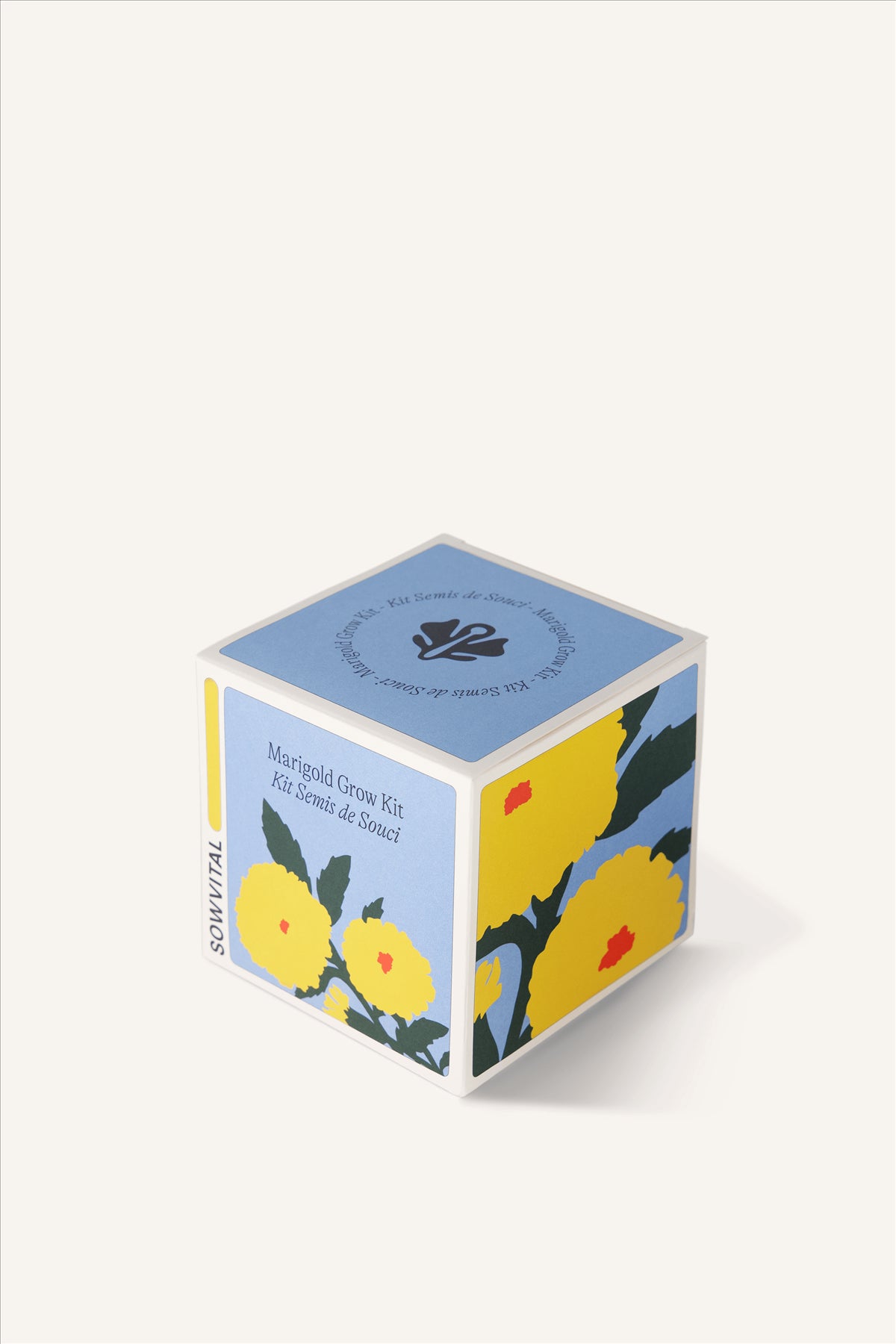 Sowvital's Marigold Seed Grow Kit from a corner angle. A square fedrigoni paper box with a playful illustration of marigold on the front and sides. The background is beige.