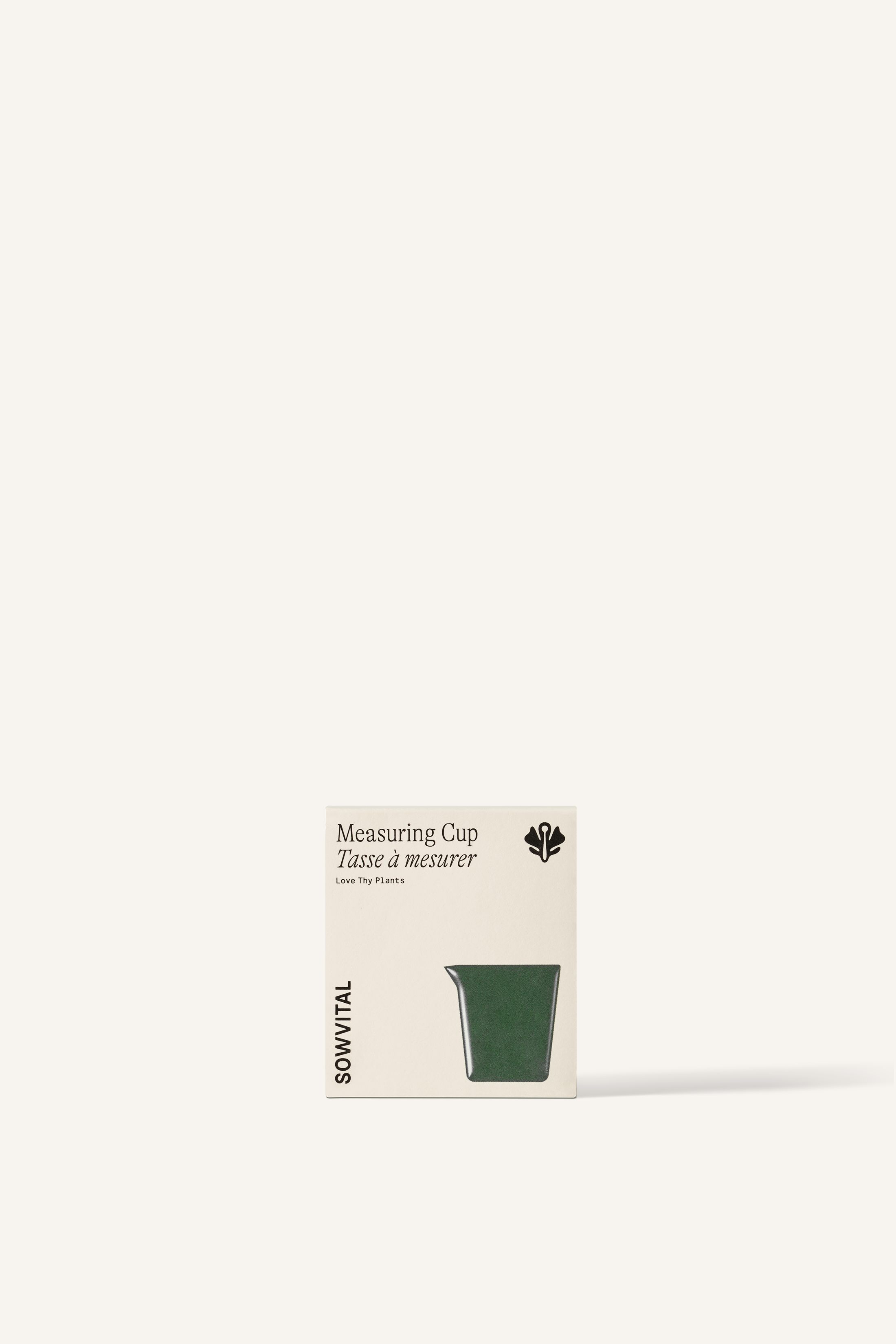 A small beige fedrigoni paper square box, embossed with the dark green shape of a measuring cup, sits in front of a beige background.