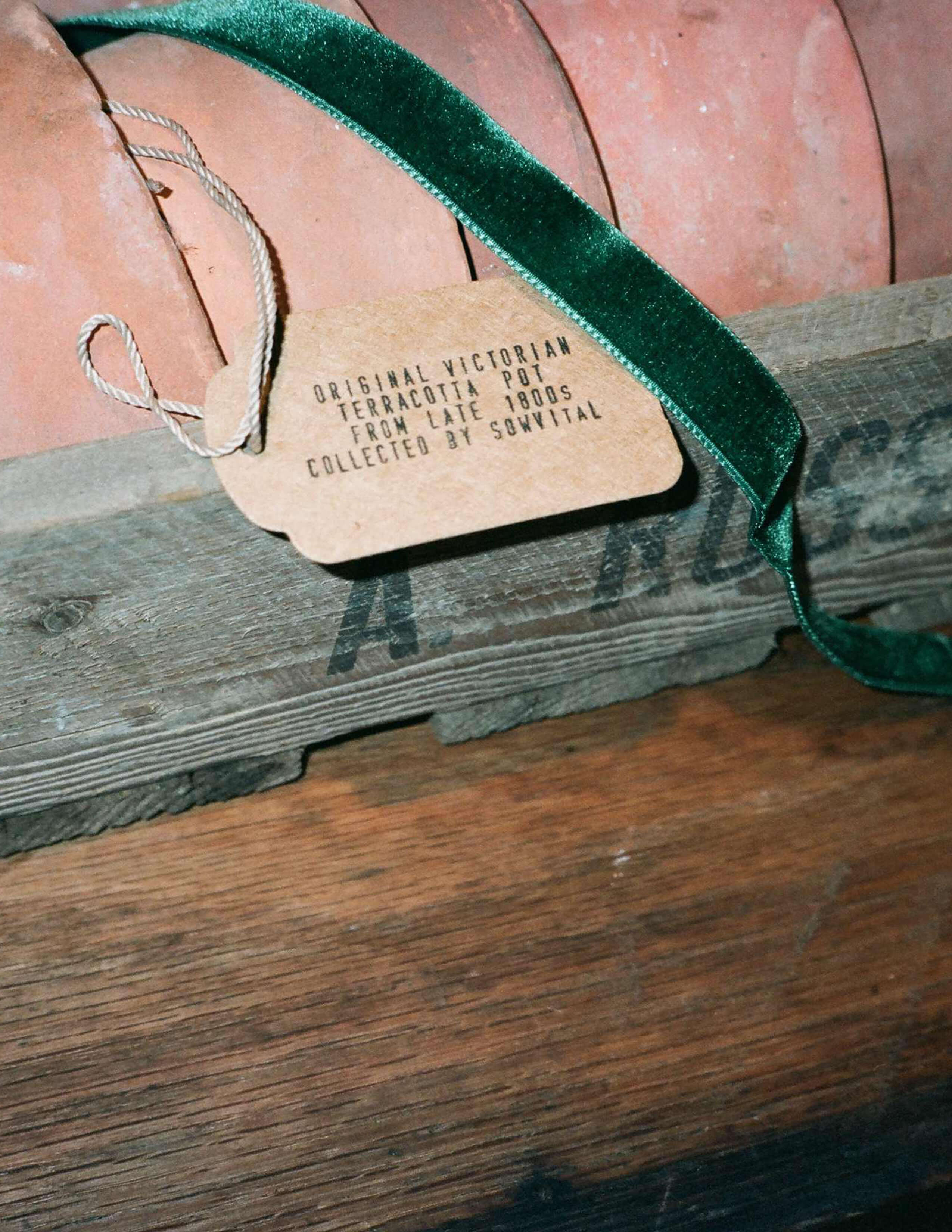 Sowvital collection of Victorian terracotta pots stocked up in a wooden crate with a green ribbon and a tag card.