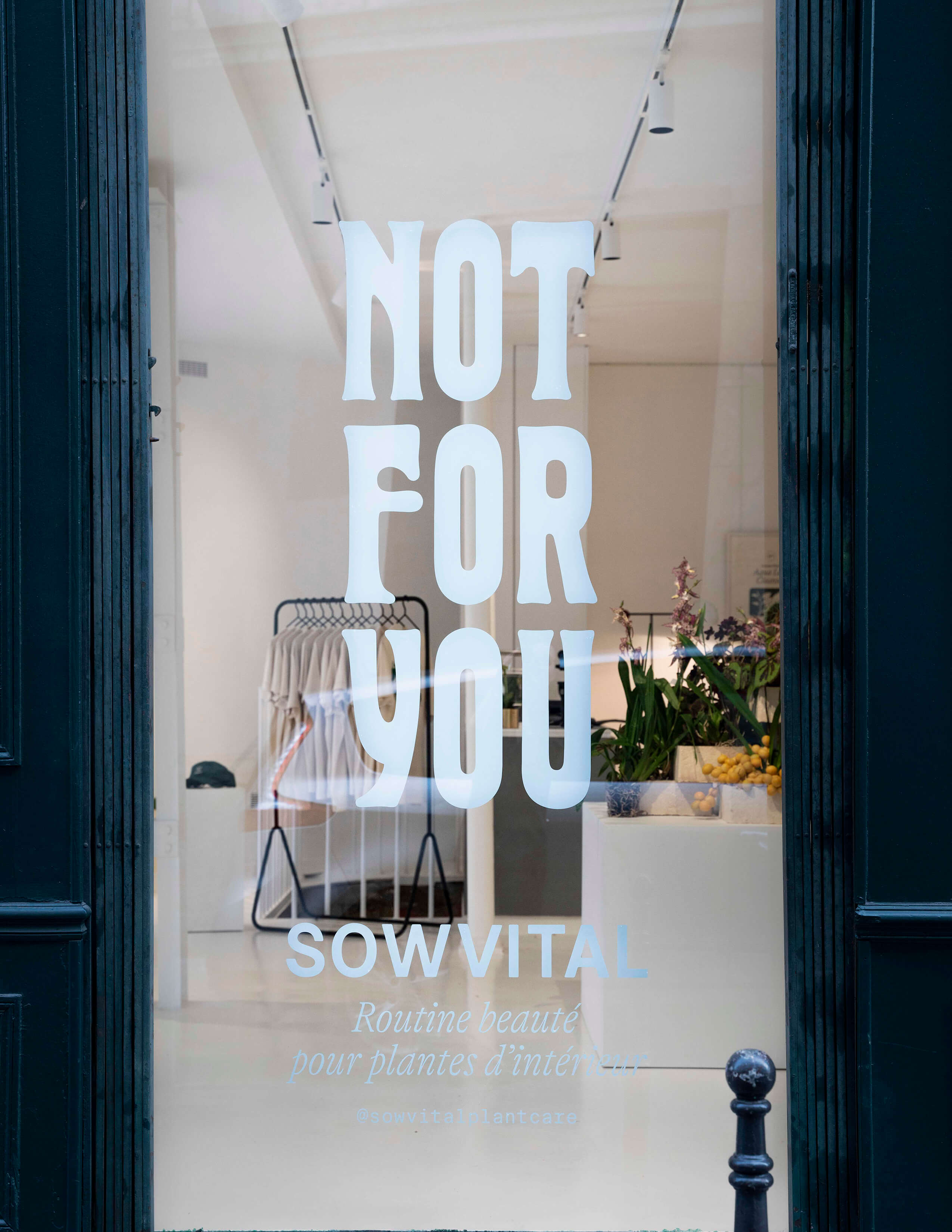 A glass shopwindow labelled with ‘Not for you’ Sowvital brand. Merchandise are being displayed nicely on clothing racks.