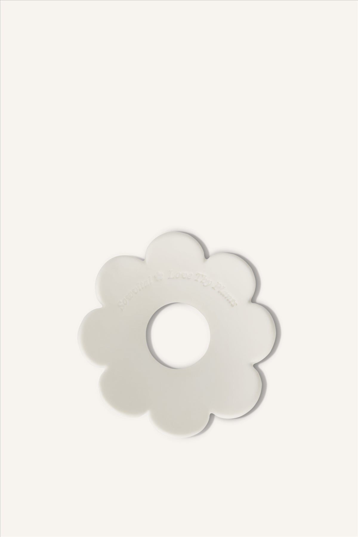 The Sowvital porcelain germination disc, a subtle flower shaped germination disc made from limoges porcelain and stamped with "Sowvital" and "Love Thy Plants".