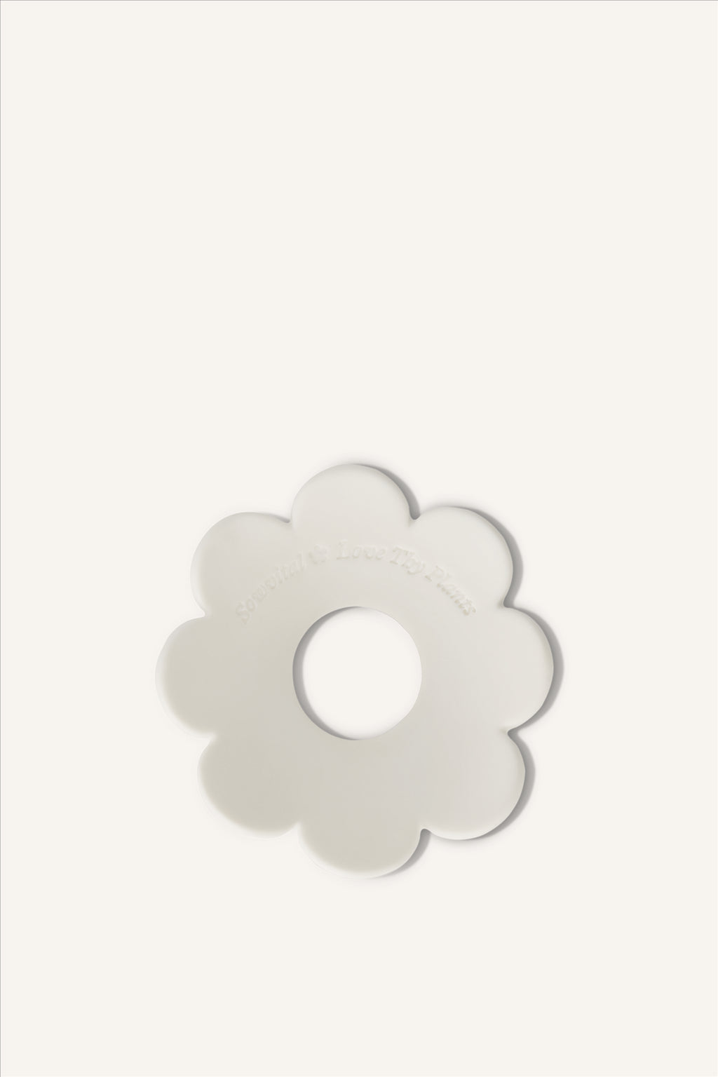 The Sowvital porcelain germination disc, a subtle flower shaped germination disc made from limoges porcelain and stamped with "Sowvital" and "Love Thy Plants".