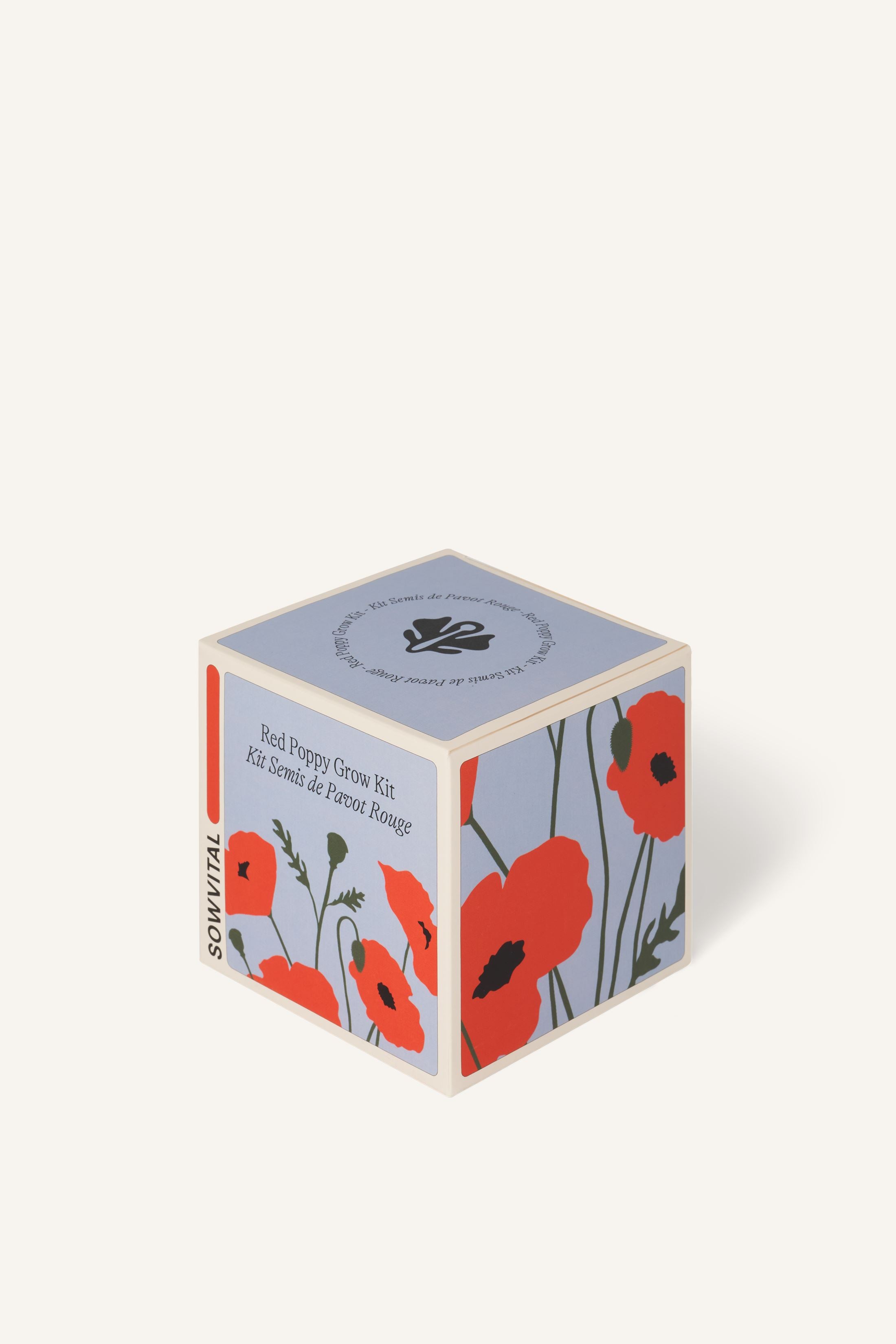 Sowvital's Red Poppy Seed Grow Kit from a corner angle. A square fedrigoni paper box with a playful illustration of red poppies on the front and sides. The background is beige.