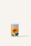 Sowvital's Sunflower Seeds. A rectangular fedrigoni paper box with a playful illustration of a sunflower on the front. The background is beige.