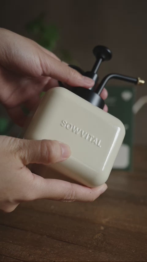 A close up of the Sowvital misting bottle used to spritz a houseplant.